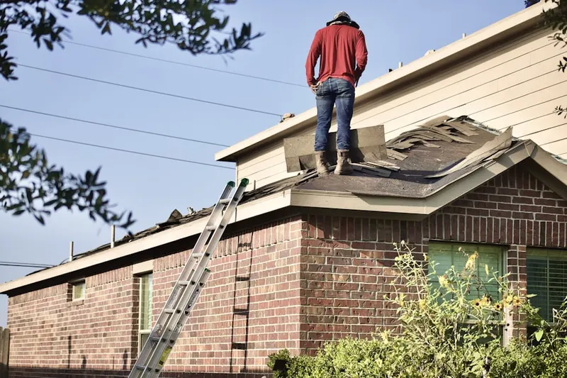 Professional roofer working on a residential roof in West Islip